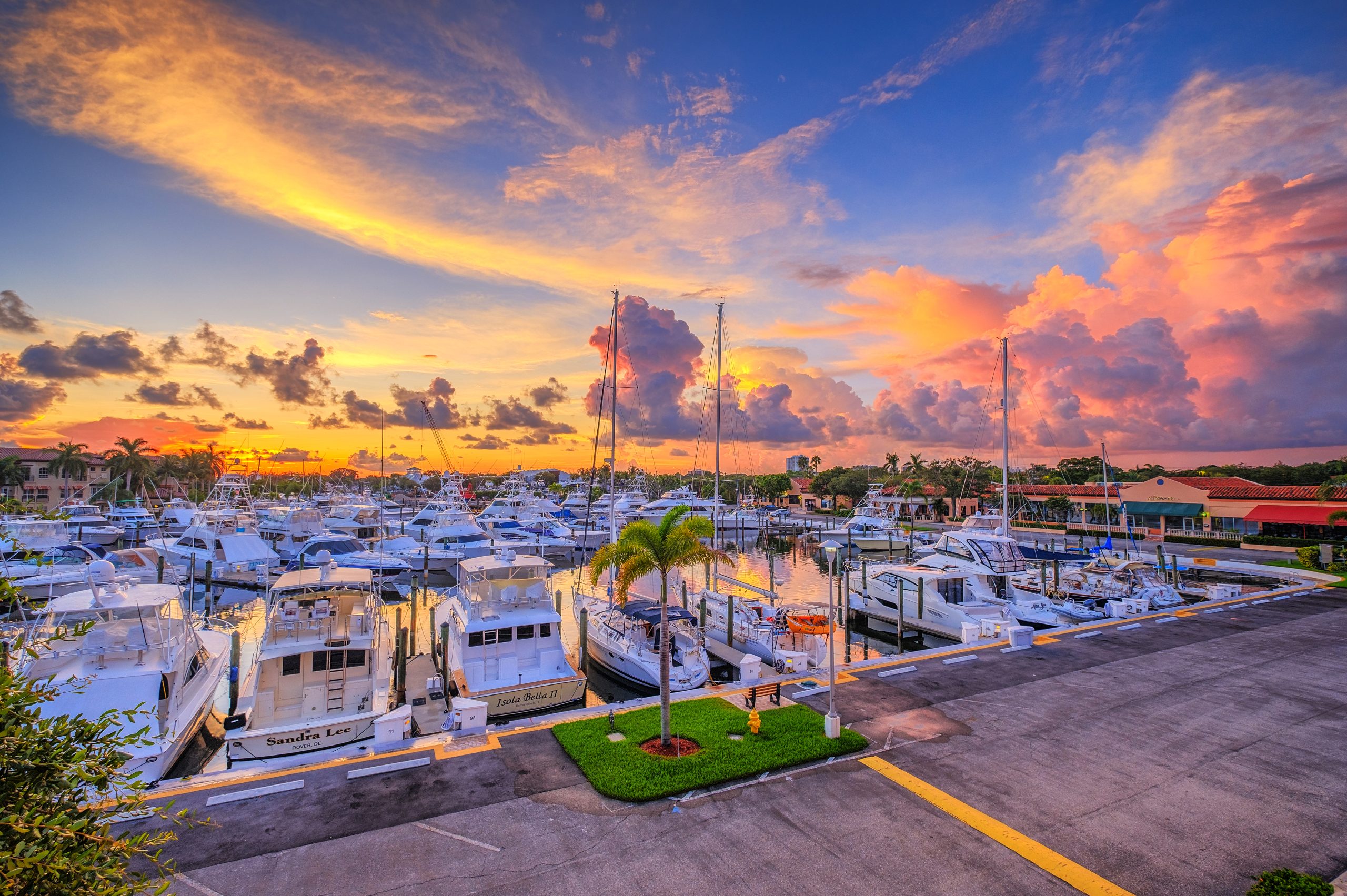 Palm Beach Gardens Marina with rows of boats all parked and anchored. Orange sunset overhead