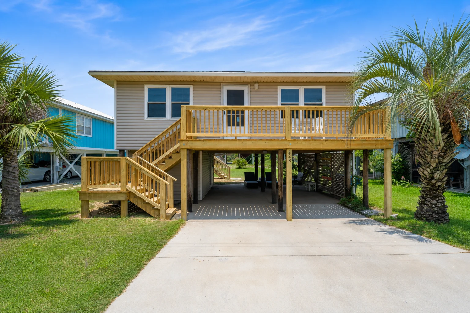 Raised cottage with front deck and palm trees, Beach Cottage