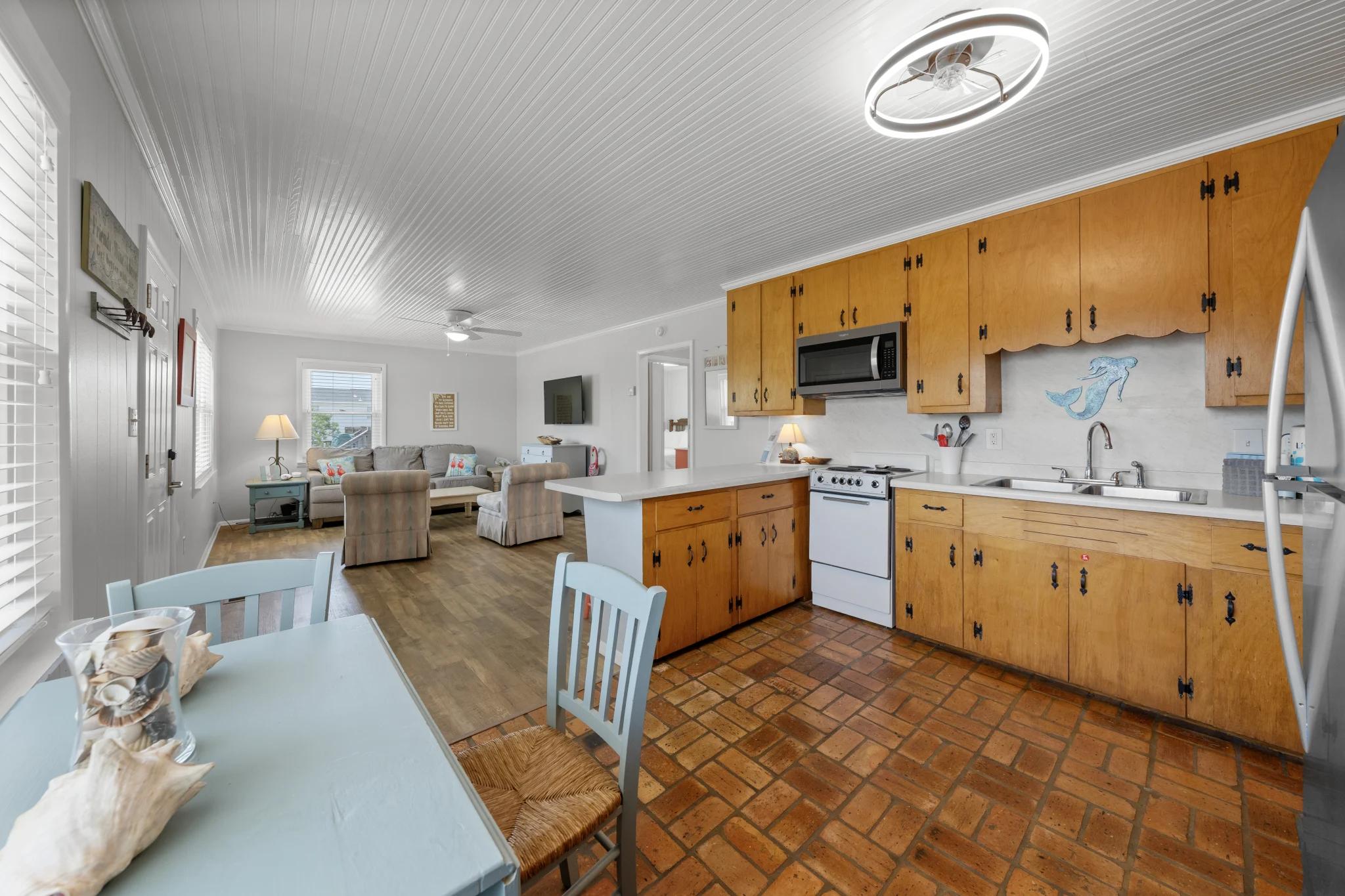 Kitchen with wood cabinets and dining table, Beach Cottage