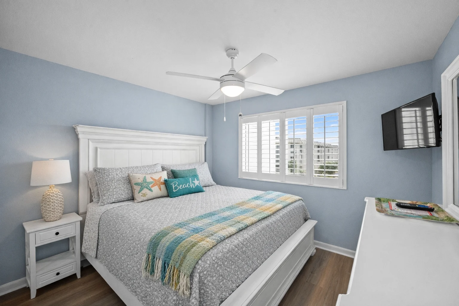 King bedroom with a TV and shuttered windows, Emerald Dreams