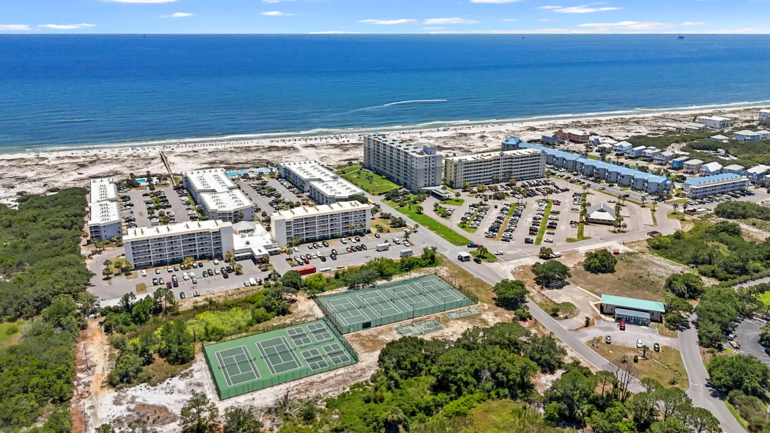 Resort grounds, tennis courts and the Gulf from the air, Emerald Dreams