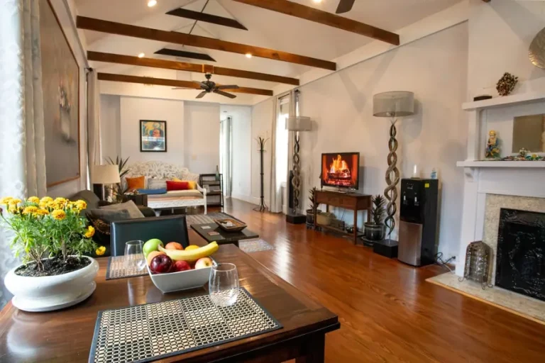 Living room with a fireplace at Lilac Lair in the Marigny