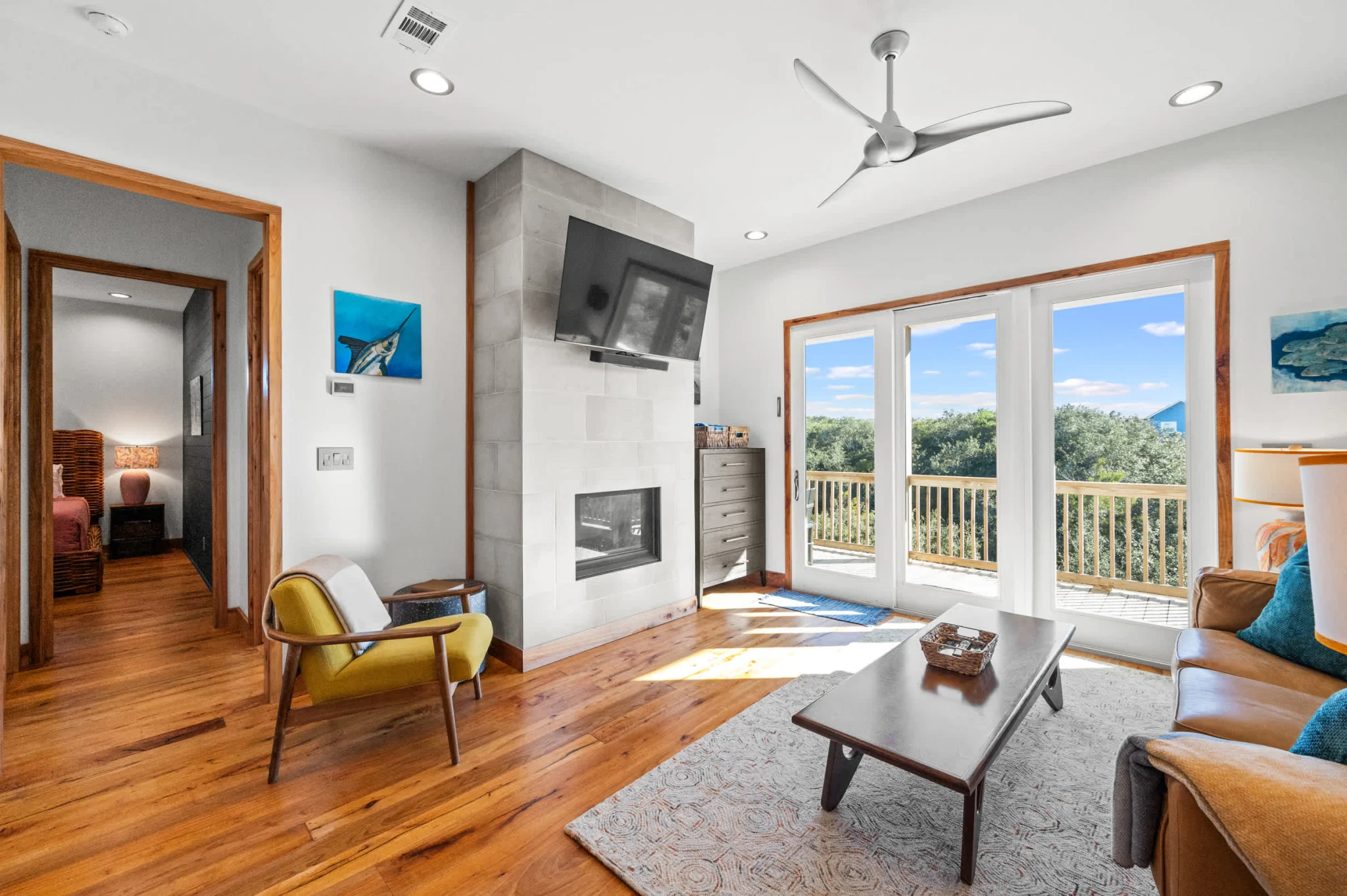 Living room with fireplace and doors to the porch, Gulf Pearl