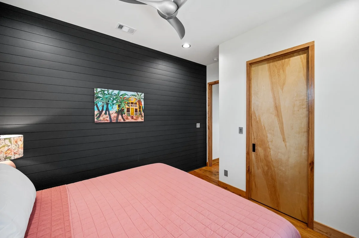 Bedroom with dark plank wall, Gulf Pearl