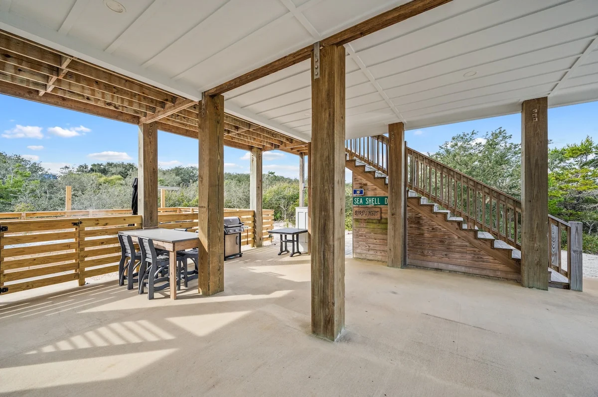 Covered patio with dining table and stairs, Gulf Pearl
