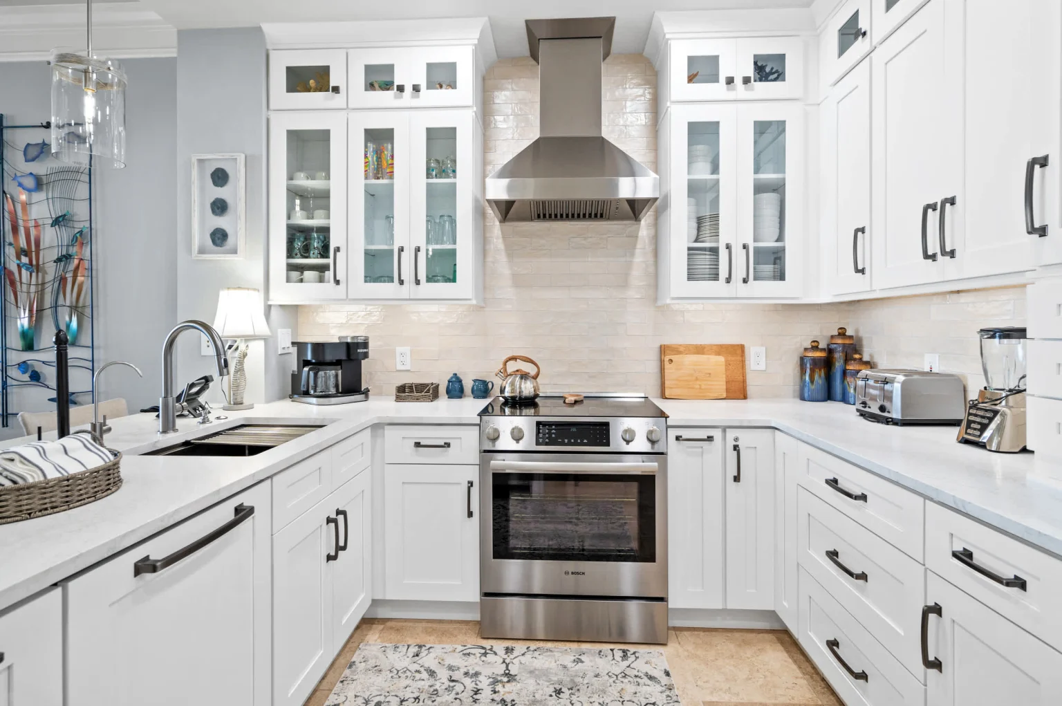 Kitchen with gas range and glass-front cabinets, High Tide Penthouse
