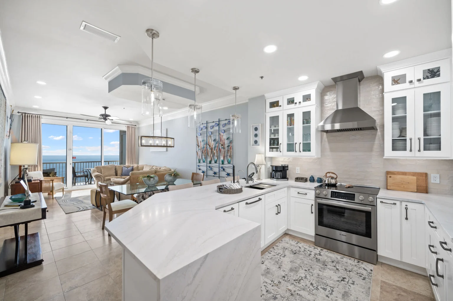 Kitchen island with the living room and Gulf view beyond, High Tide Penthouse