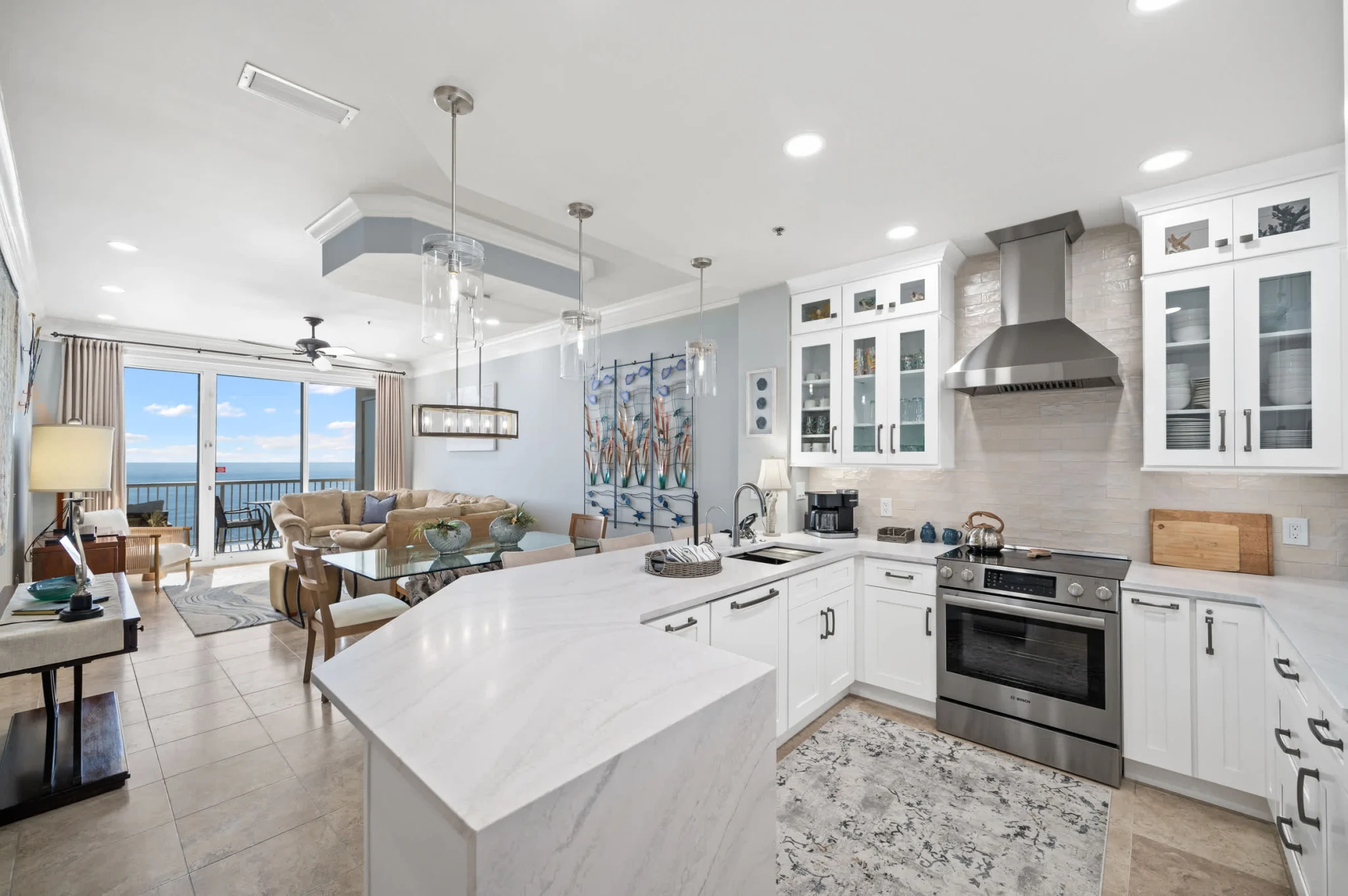 Kitchen island with the living room and Gulf view beyond, High Tide Penthouse