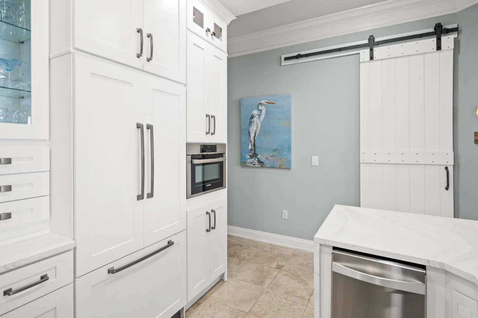 Kitchen with built-in refrigerator and barn door, High Tide Penthouse