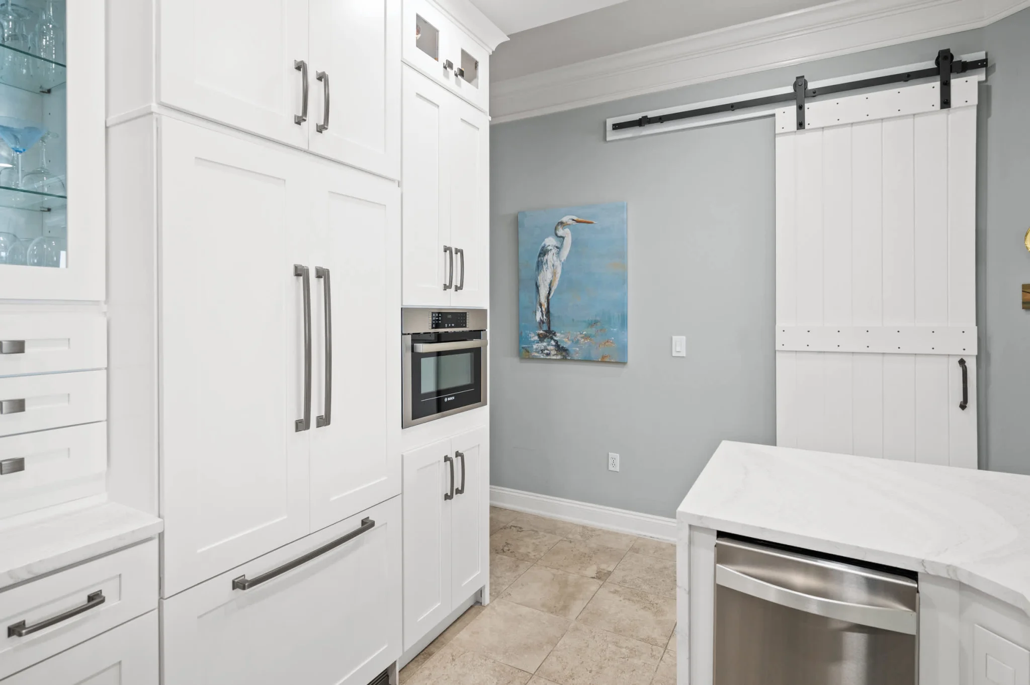 Kitchen with built-in refrigerator and barn door, High Tide Penthouse