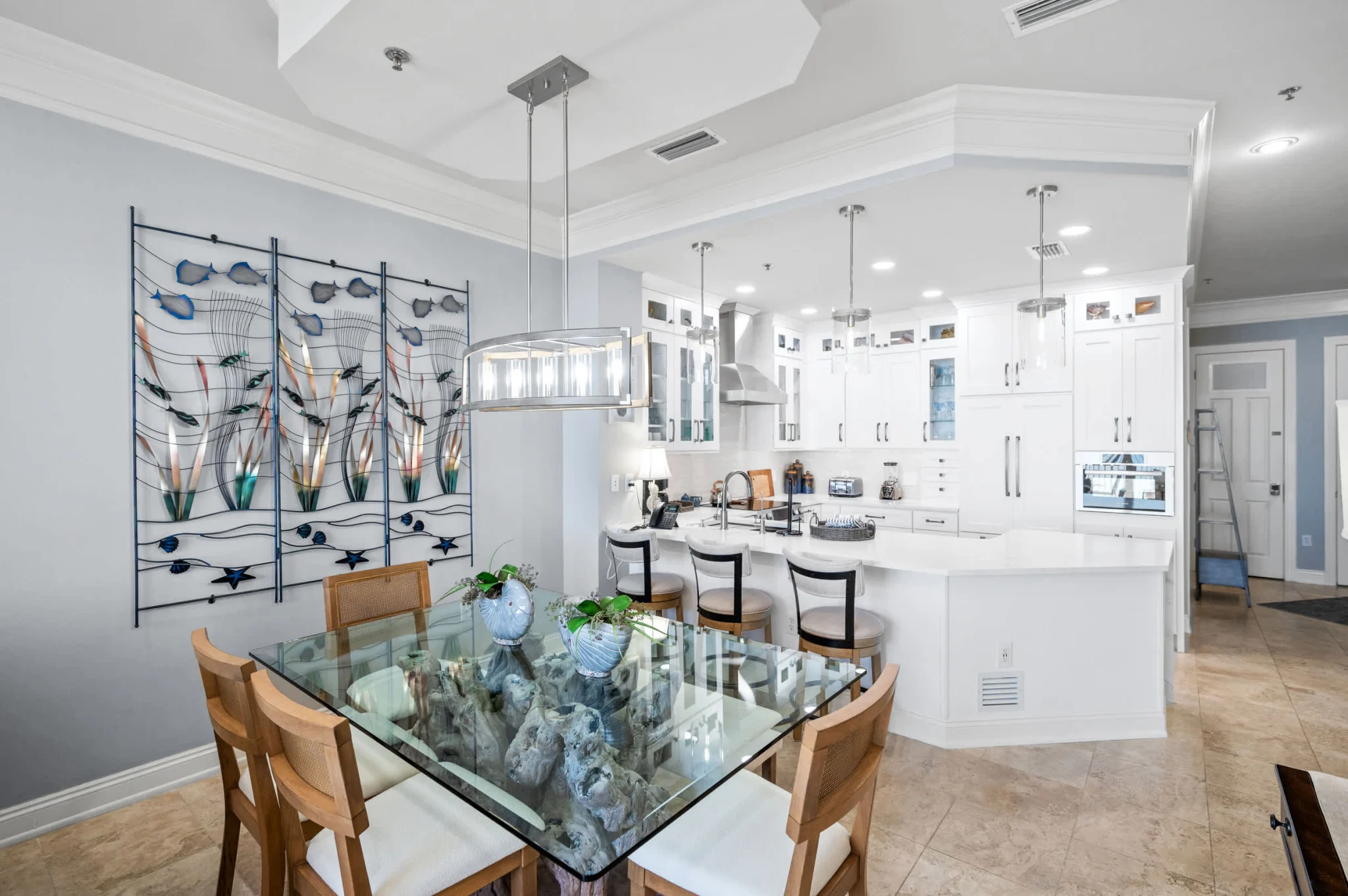 Glass dining table beside the kitchen, High Tide Penthouse