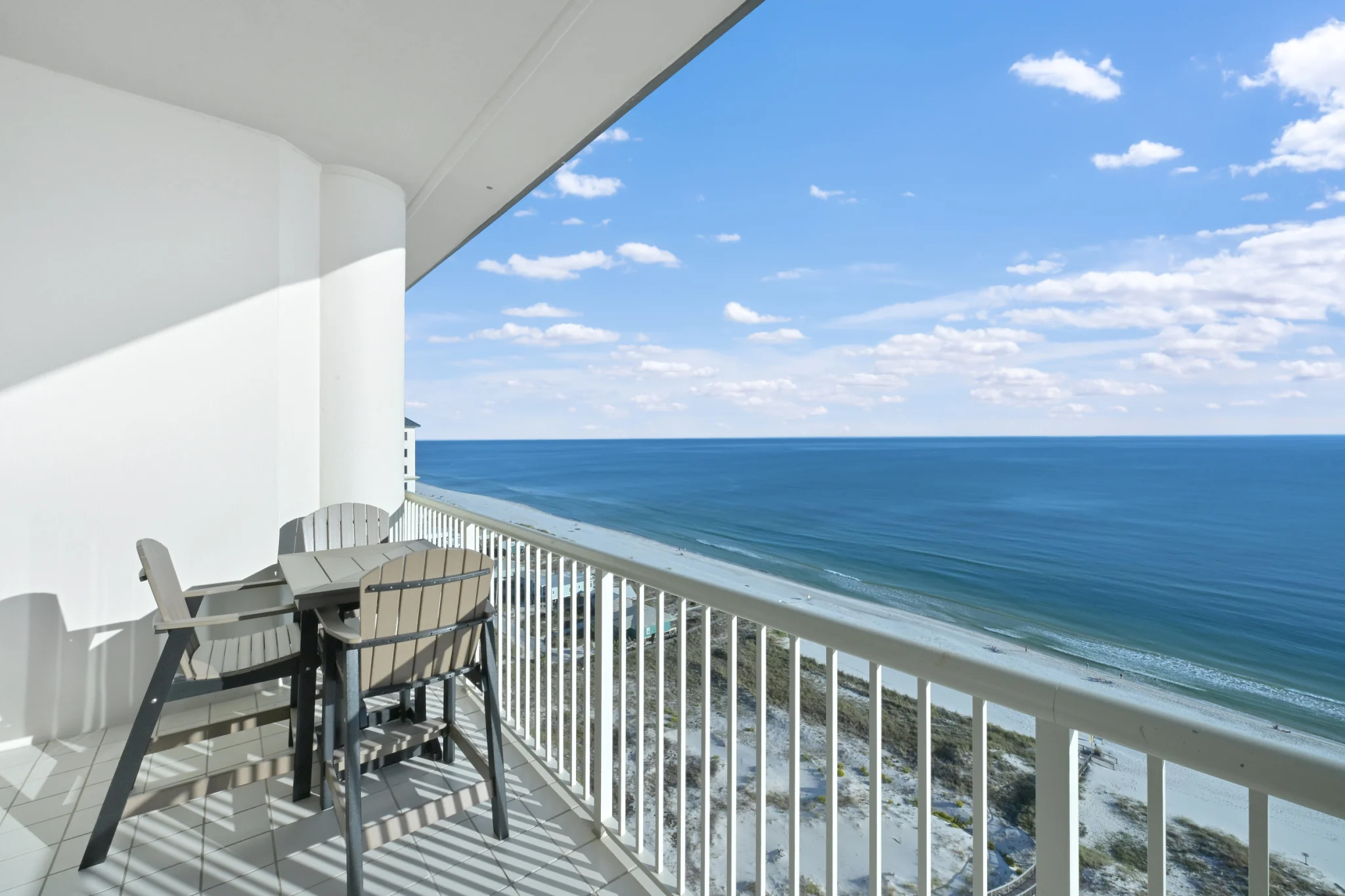 Balcony dining table high above the beach, High Tide Penthouse