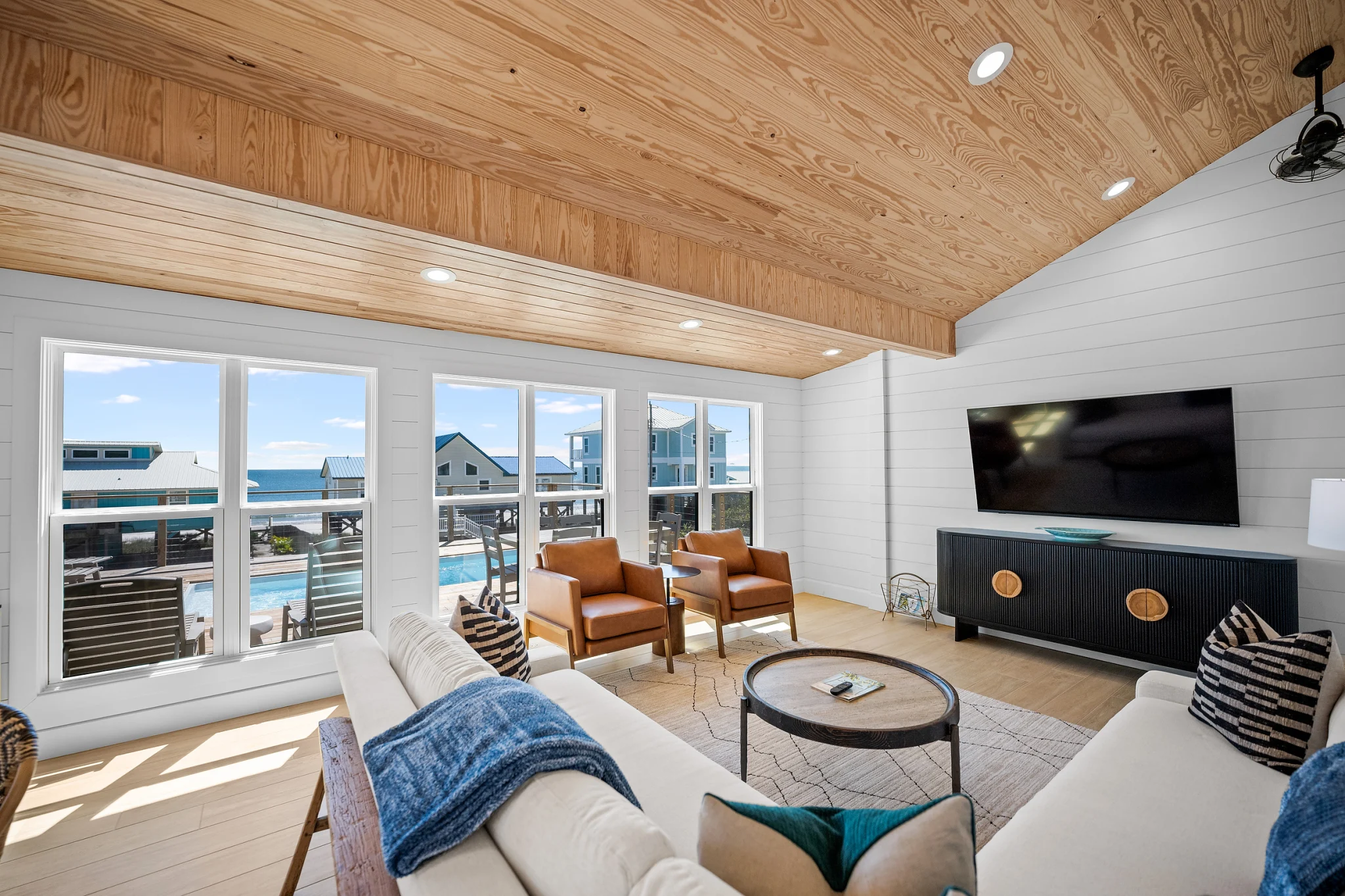 Living room with sectional and pool-view windows, Love Shack