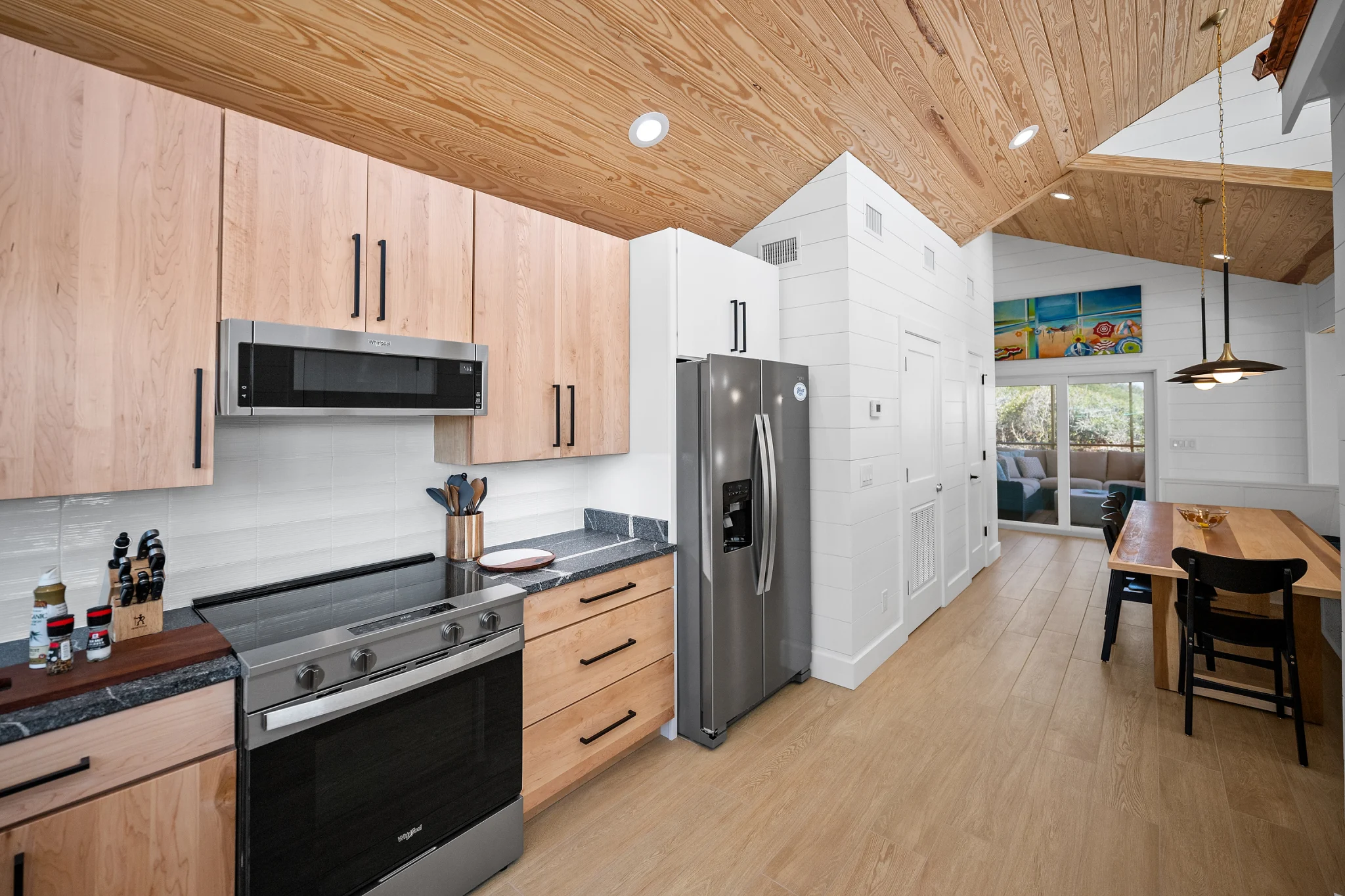 Kitchen with refrigerator and dining table beyond, Love Shack