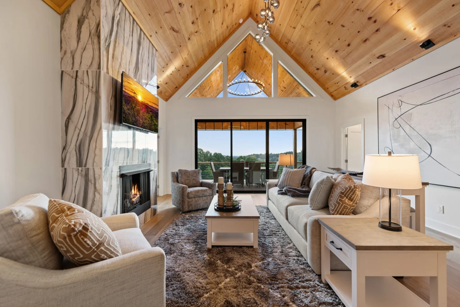 Great room with a vaulted wood ceiling and stone fireplace, Modern Overlook