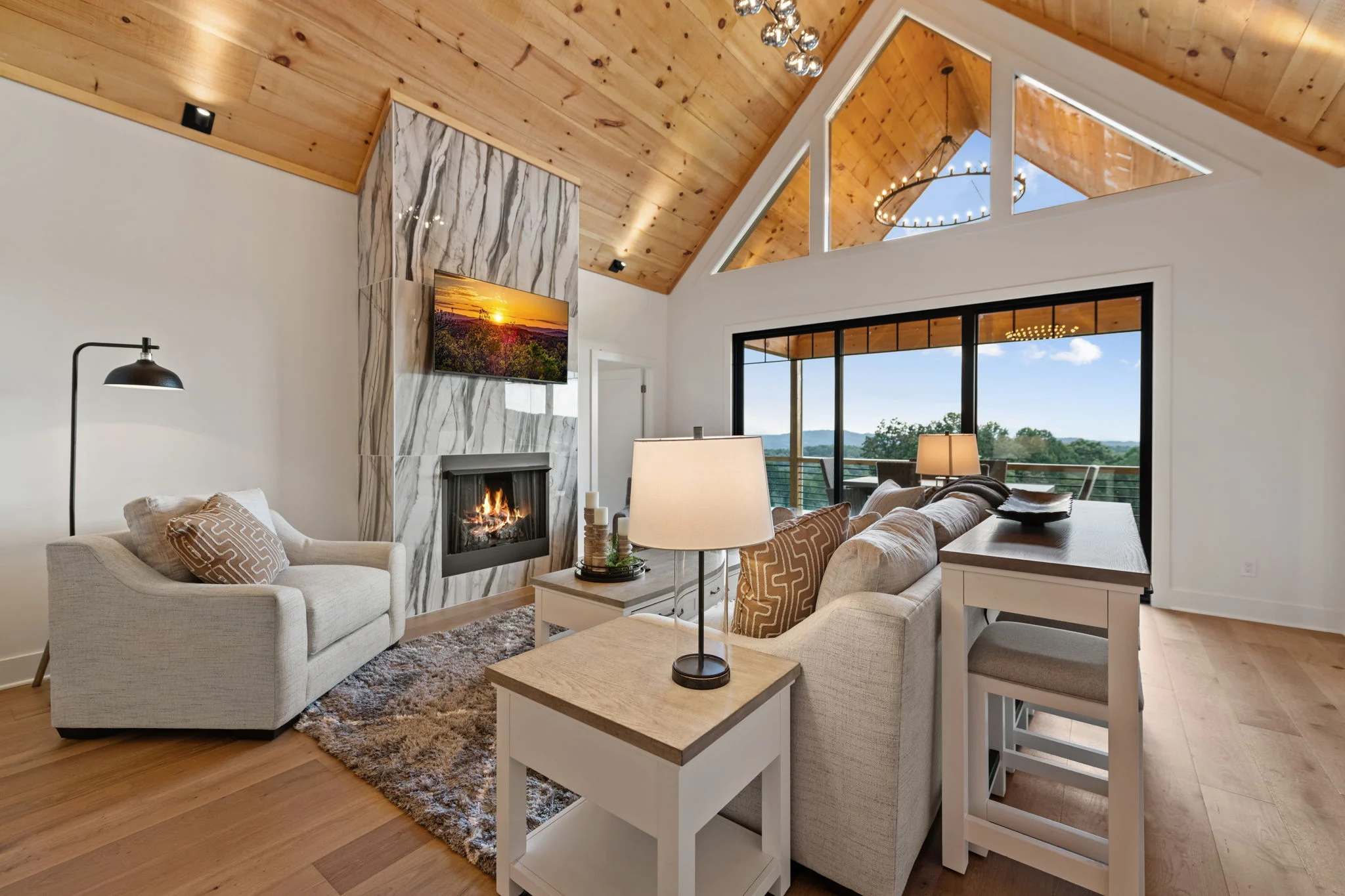 Great room with a vaulted wood ceiling and stone fireplace, Modern Overlook