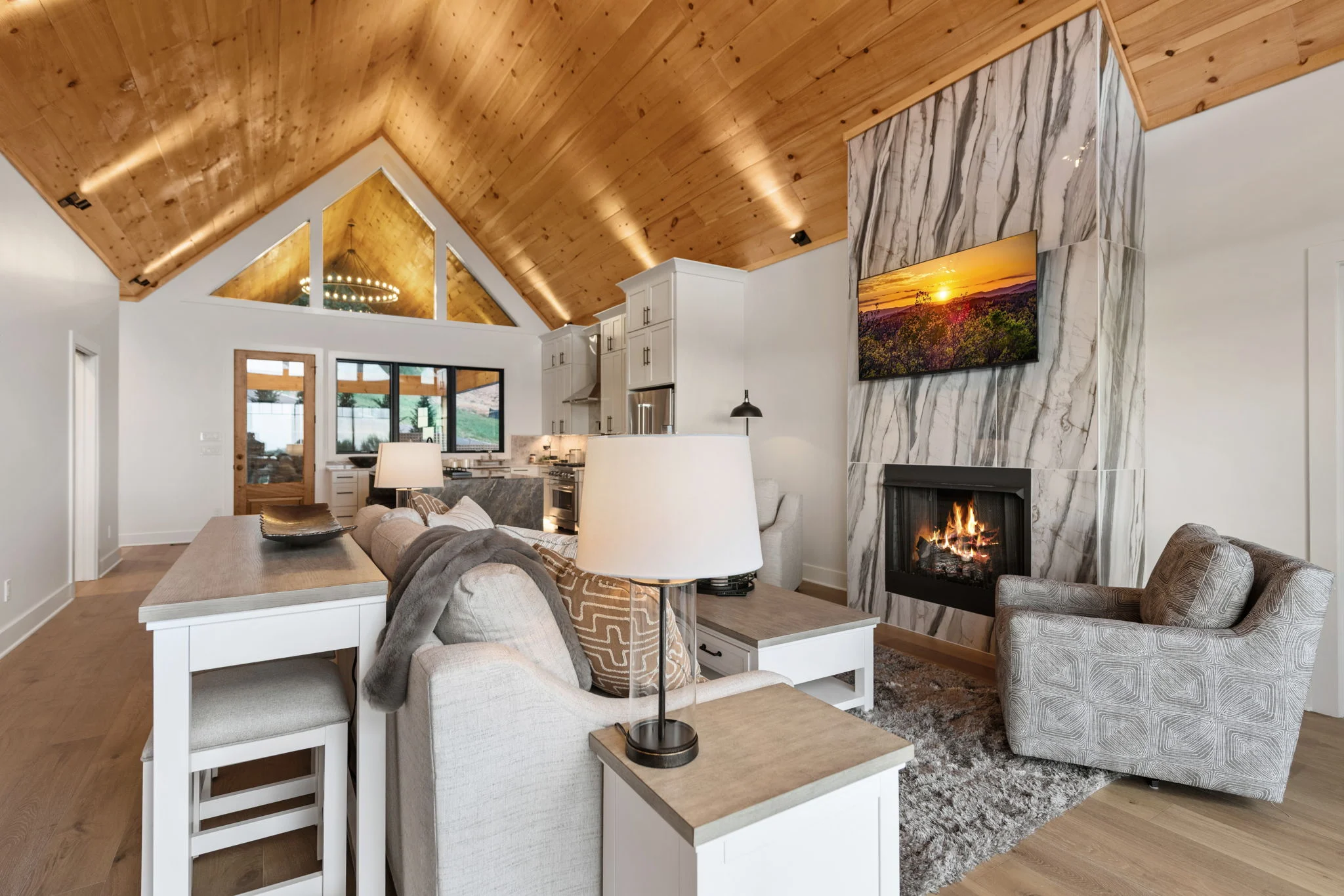 Great room with a vaulted wood ceiling and stone fireplace, Modern Overlook