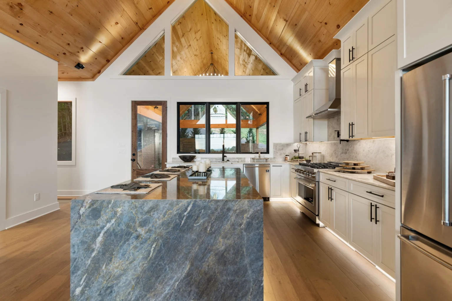 Chef's kitchen with a large stone island, Modern Overlook