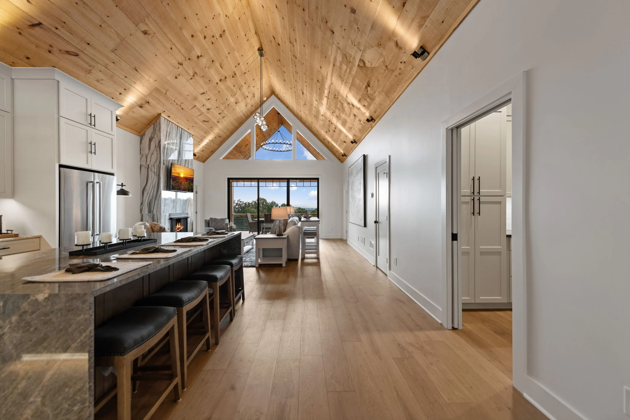 Chef's kitchen with a large stone island, Modern Overlook