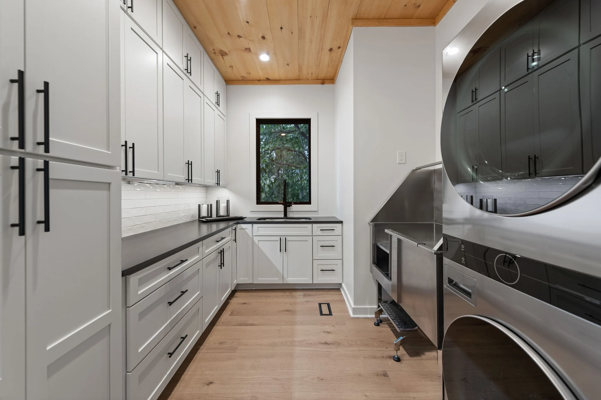 Laundry room with a stacked washer and dryer, Modern Overlook