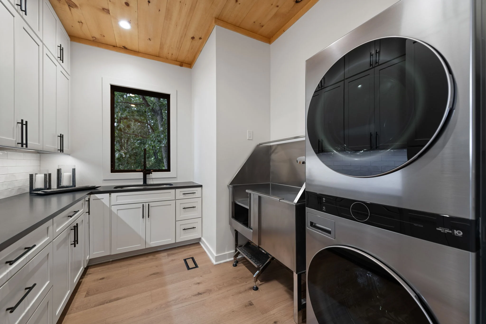 Laundry room with a stacked washer and dryer, Modern Overlook