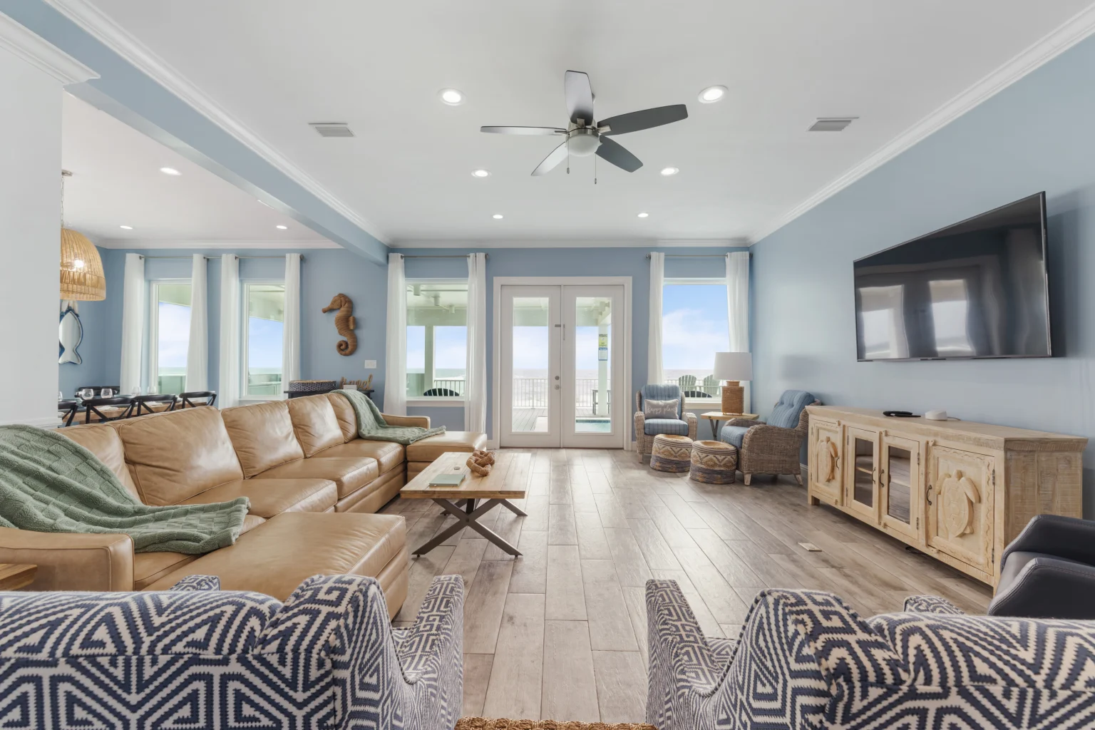 Living room with leather sectional and French doors to the deck, Sea Bliss