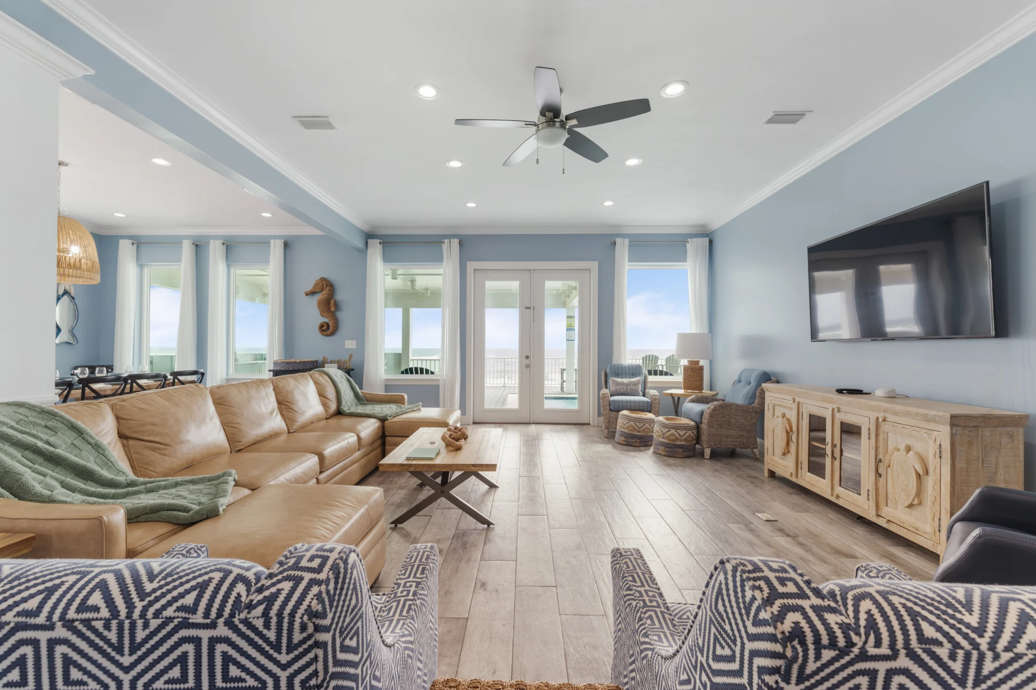 Living room with leather sectional and French doors to the deck, Sea Bliss