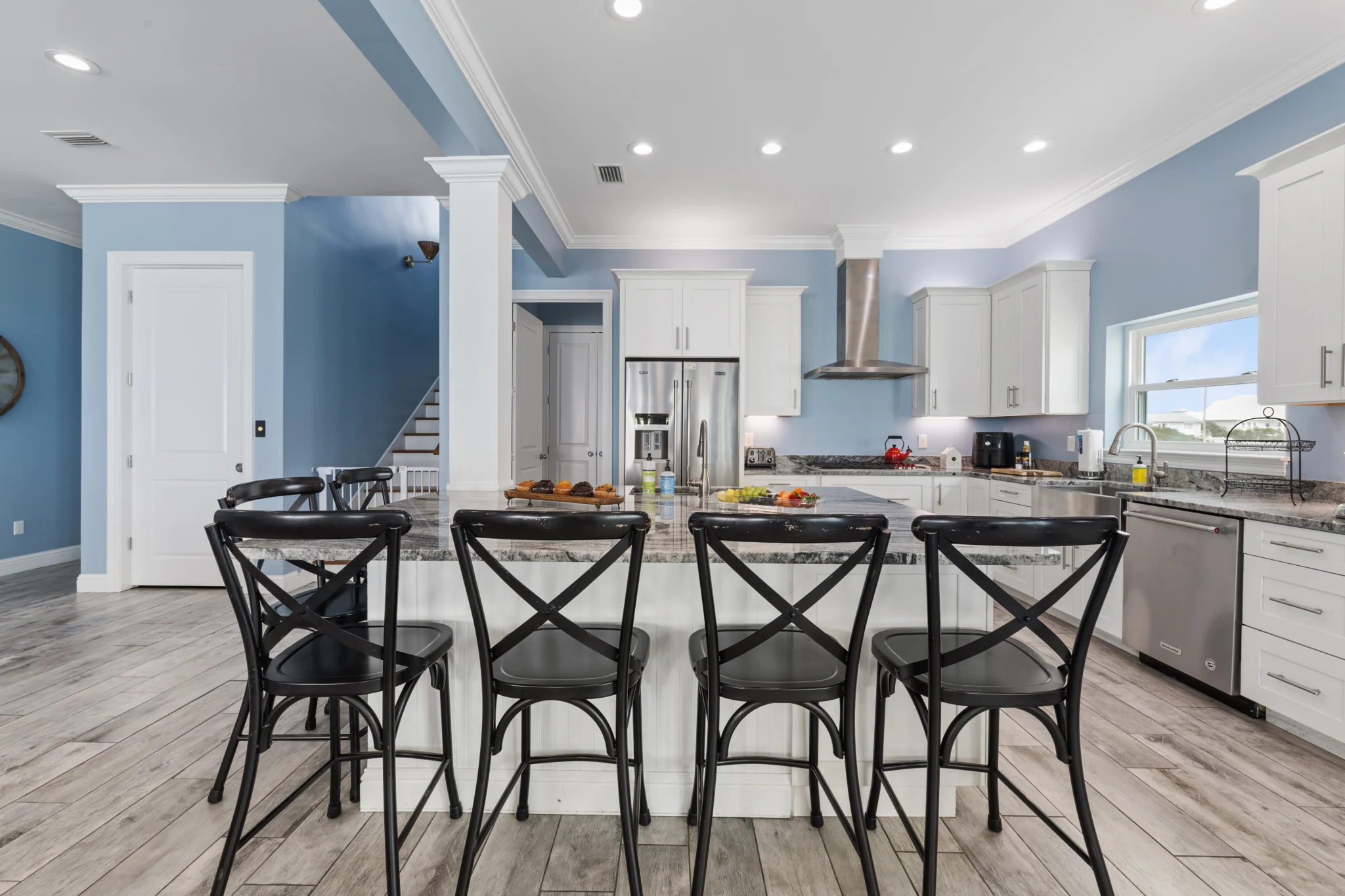 Bar stools at the island with the kitchen behind, Sea Bliss