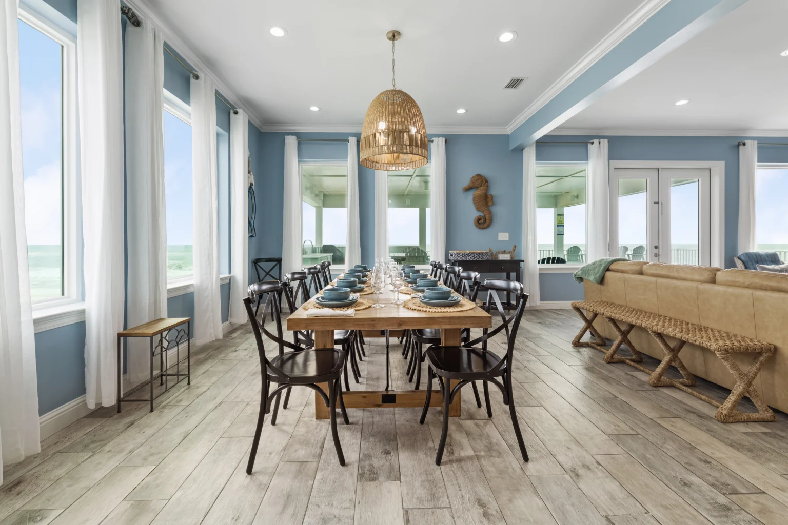 Dining table set for a group with Gulf-view windows, Sea Bliss