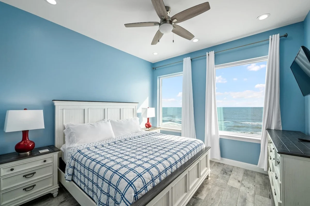 King bedroom with plaid bedding and Gulf views, Sea Bliss