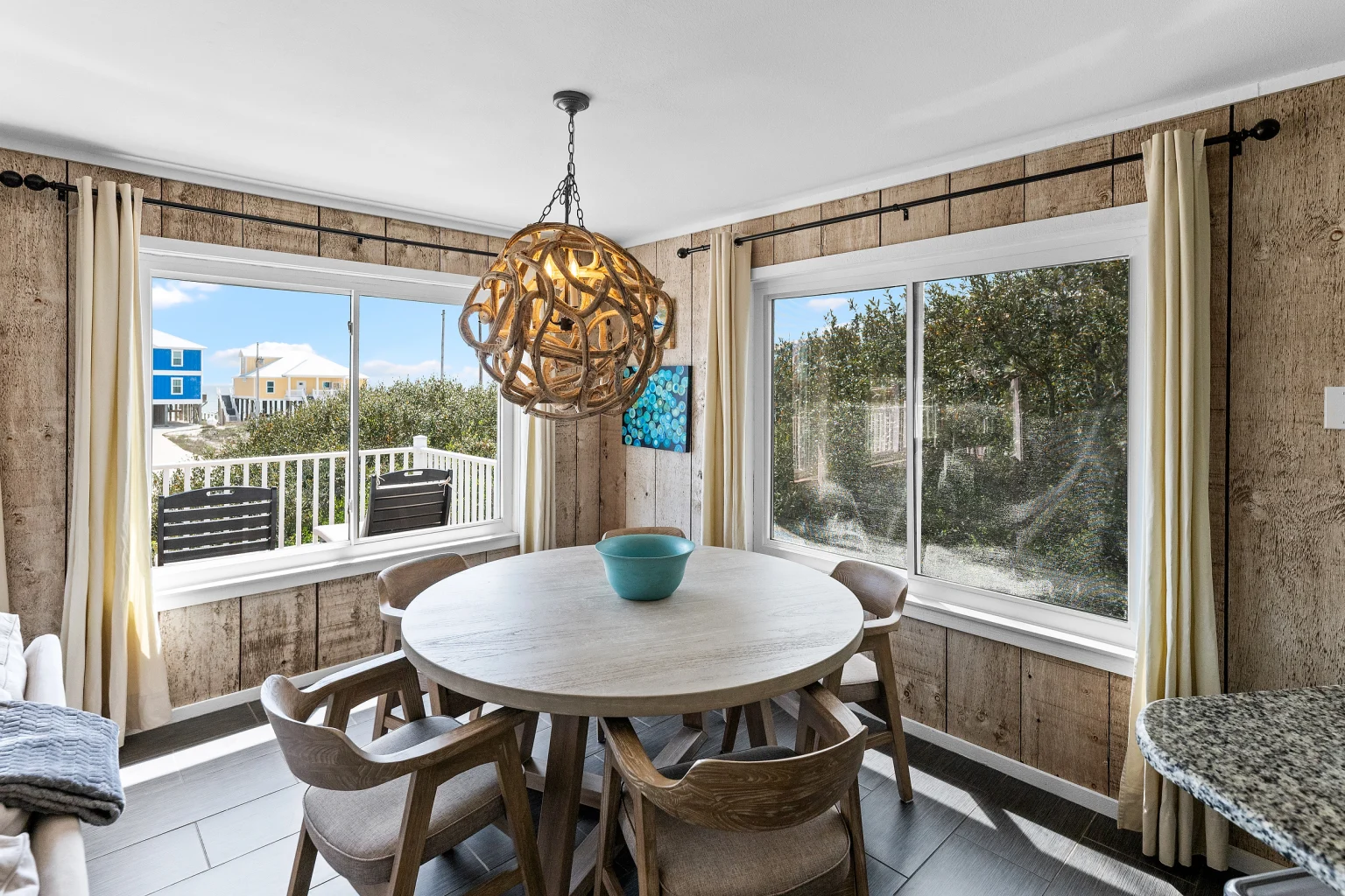 Round dining table under a rope pendant, Sea Forever