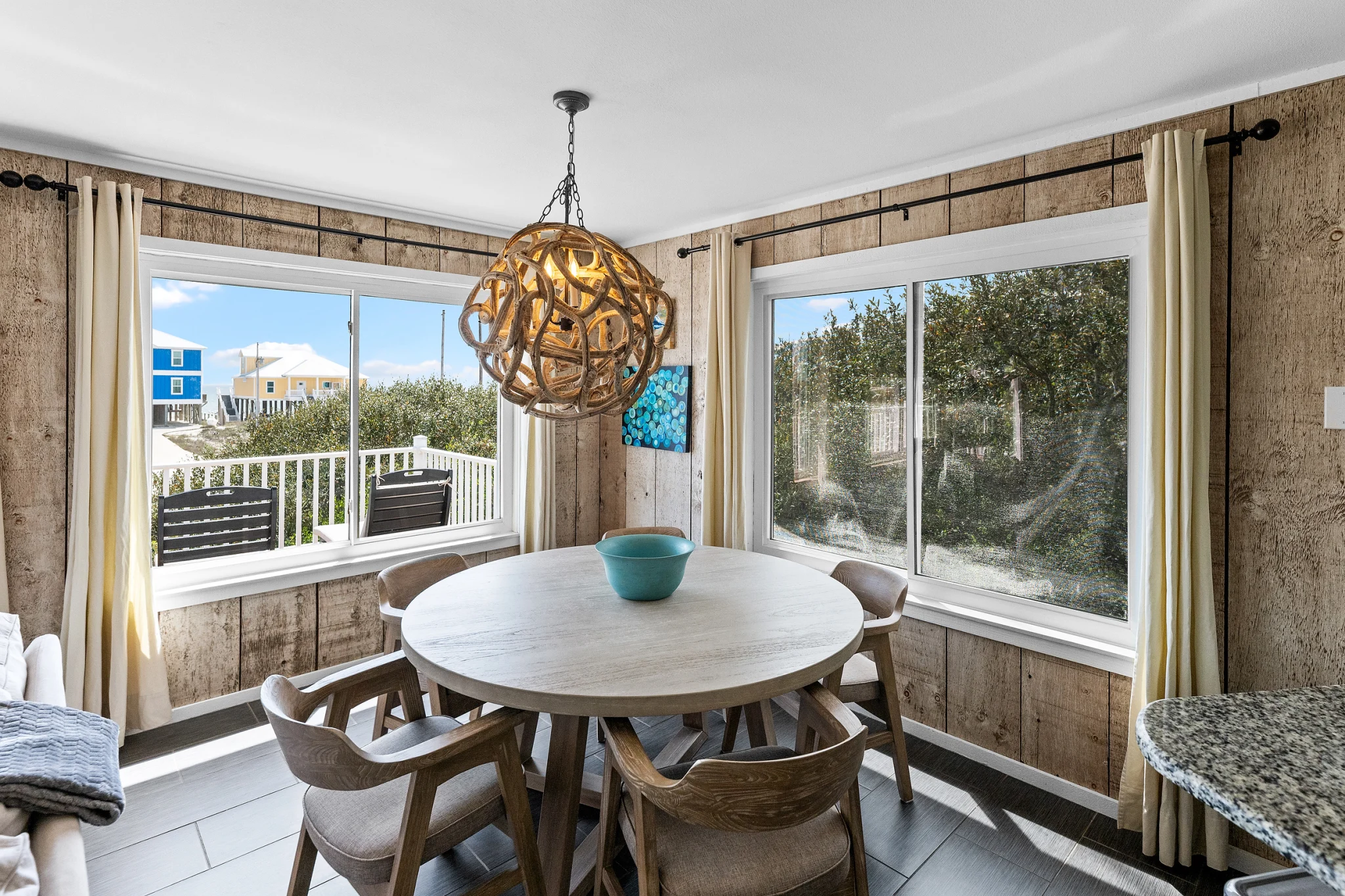 Round dining table under a rope pendant, Sea Forever