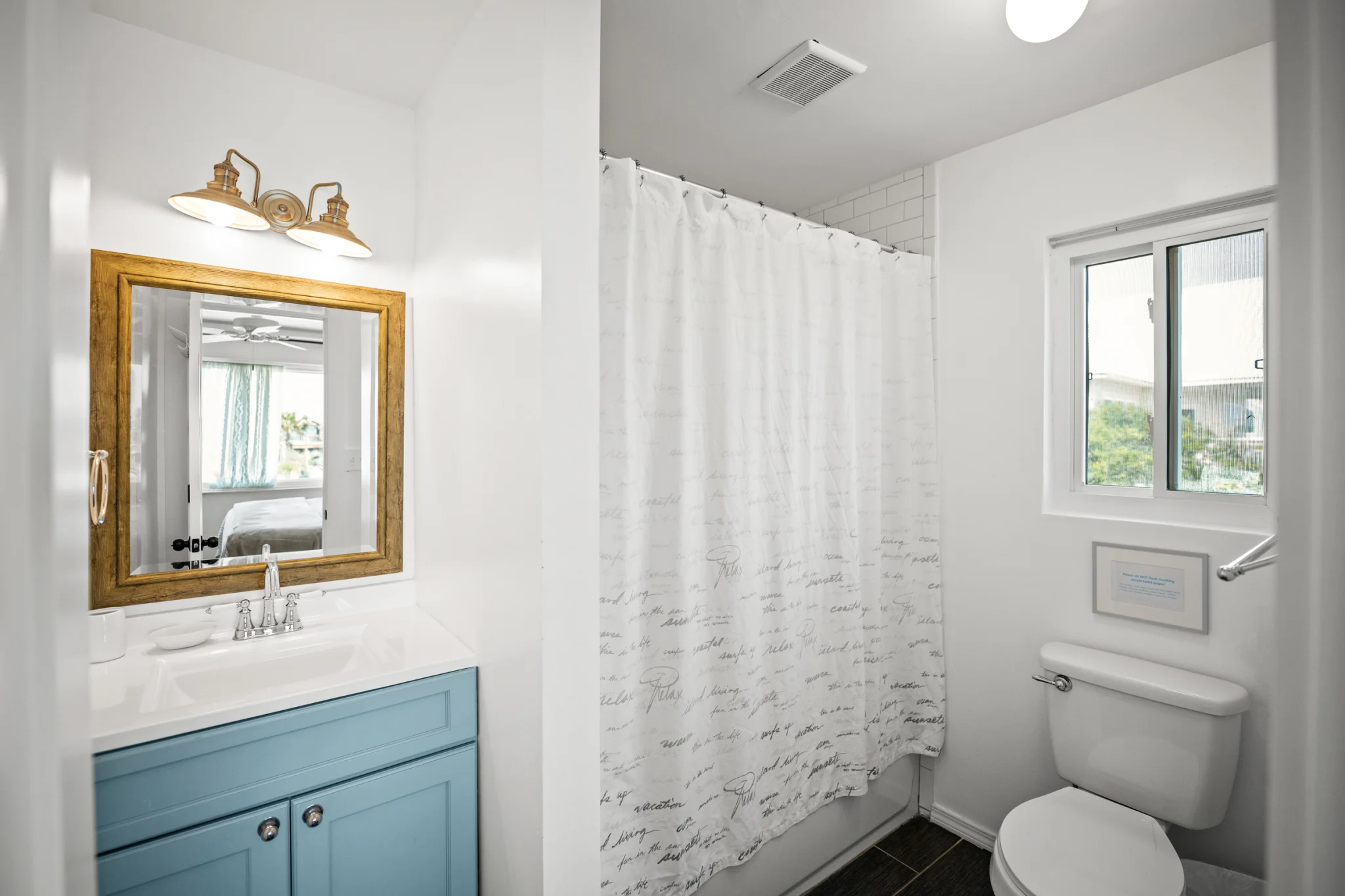 Bathroom with blue vanity and tub, Sea Forever