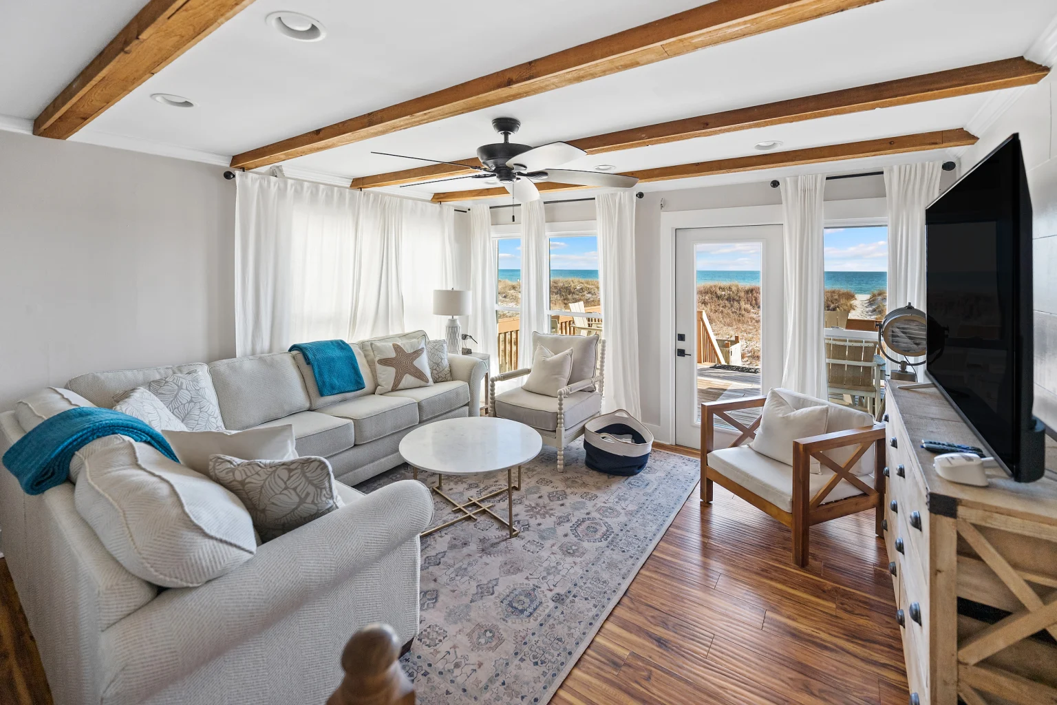 Living room with doors to the Gulf-view deck, SouthWind East