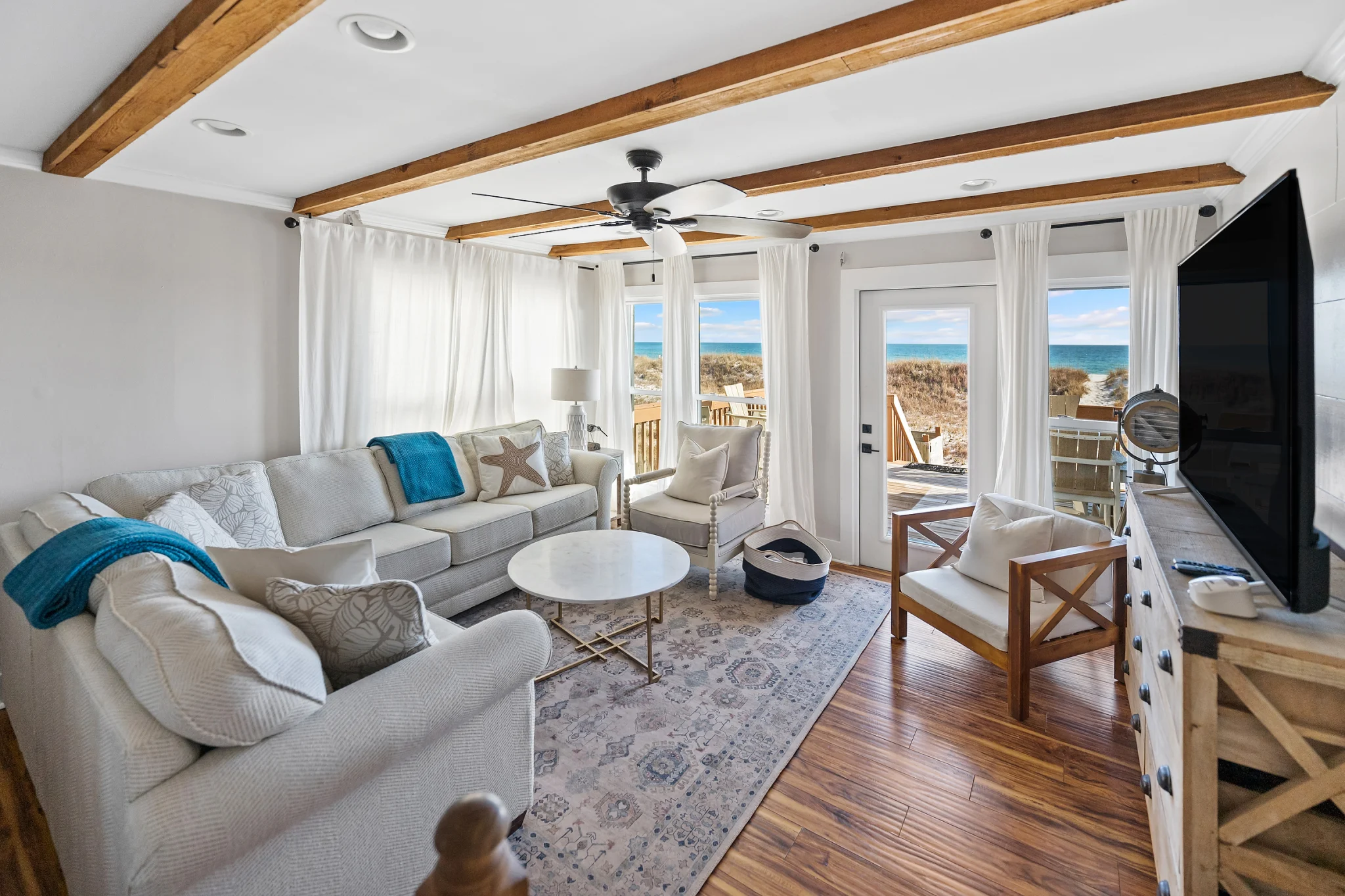 Living room with doors to the Gulf-view deck, SouthWind East