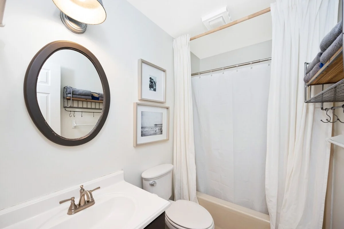 Bathroom with round mirror and tub, SouthWind West