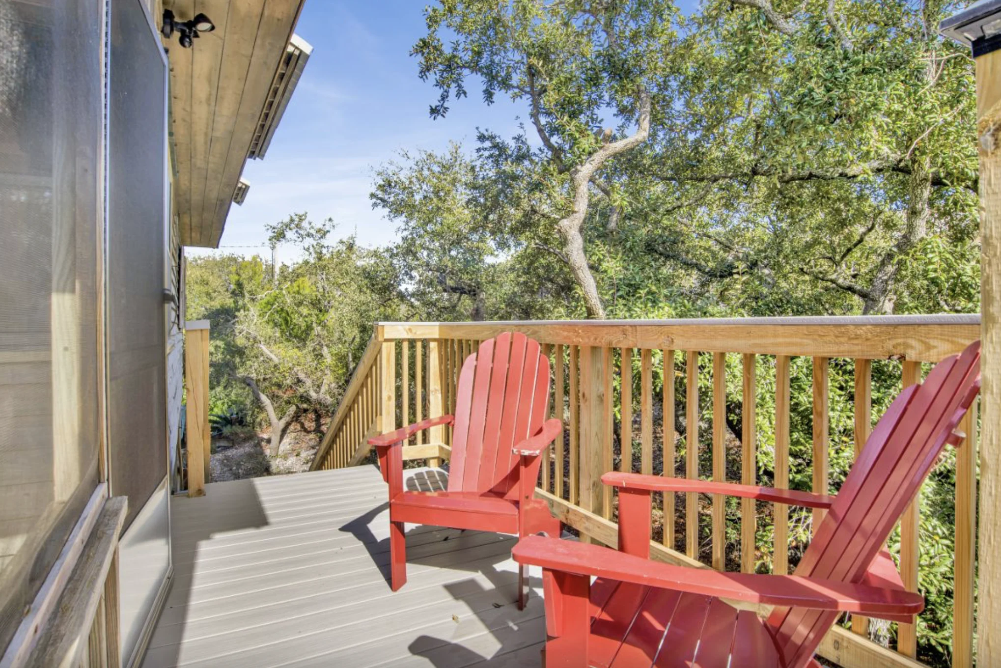 Deck with red Adirondack chairs under the oaks, Tree Tops