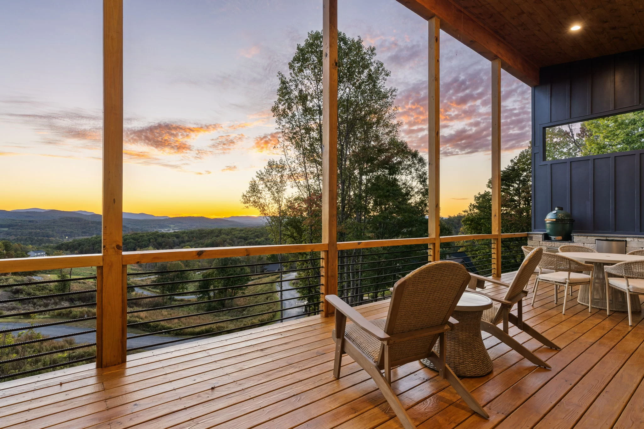 Covered deck at sunset with Adirondack chairs and mountain views, View Finder II