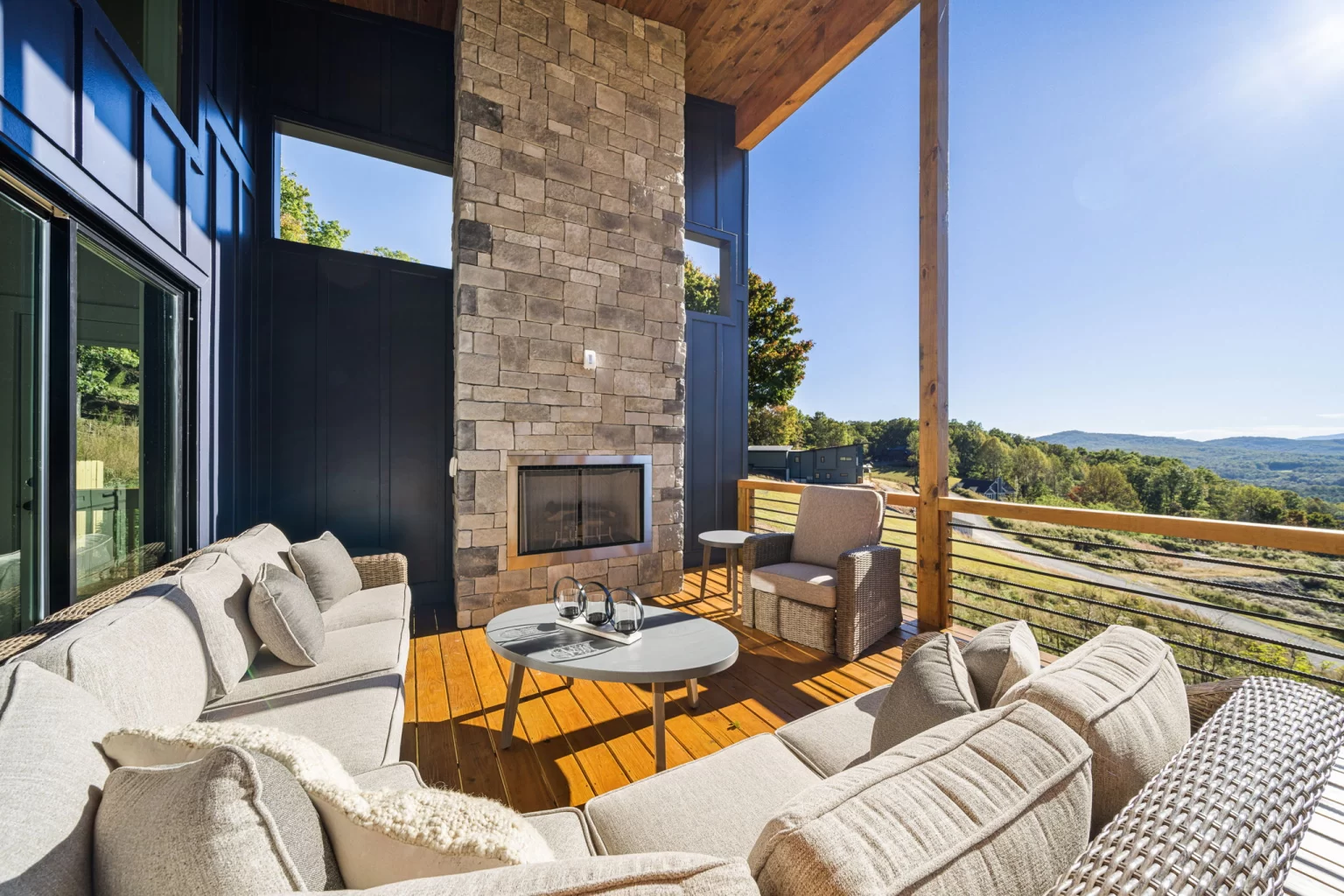 Outdoor lounge by the stone fireplace, mountains beyond, View Finder II