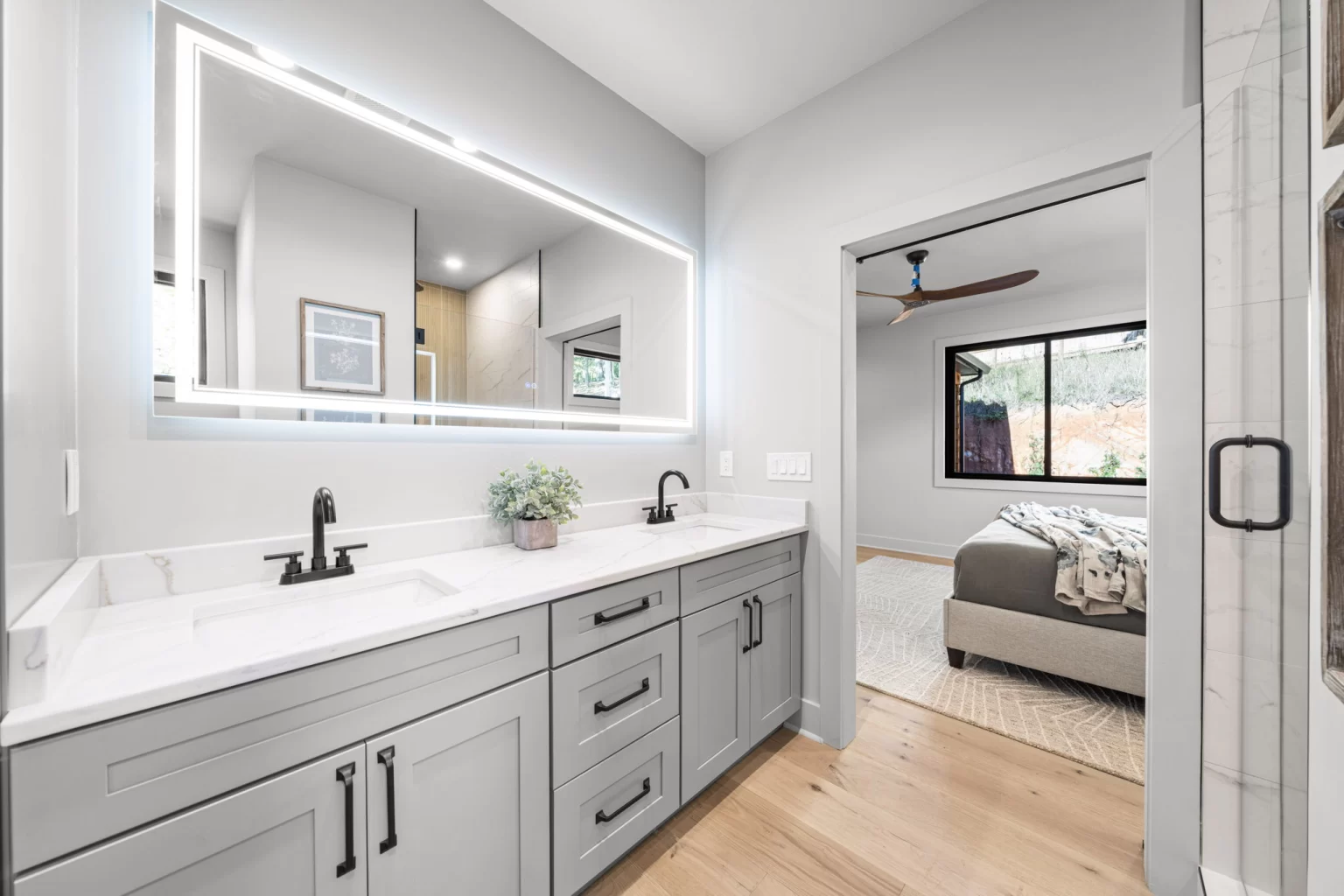 Double vanity with a lit mirror, bedroom beyond, View Finder II